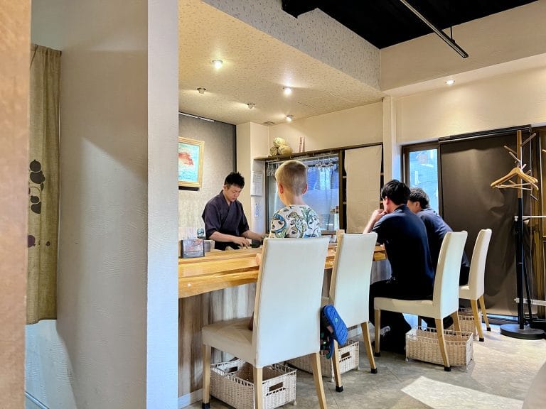 Sushi-etiquette in Japan: dit moet je weten – Kitsune Travel Mason kijkend naar sushi chef